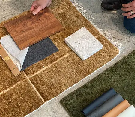 Designer arranging wood and finish samples for custom furniture build – First Class MasterCraft Fort Lee