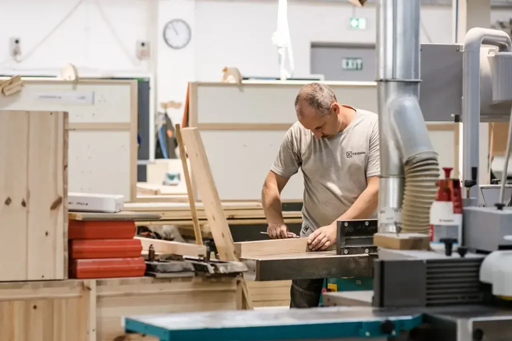 “Master craftsman operating table saw during custom furniture build — First Class MasterCraft Fort Lee workshop”
