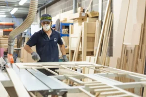 Team member preparing materials for custom bed build – First Class MasterCraft upholstery and cabinetry