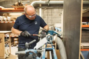First Class MasterCraft team member assembling custom bed frame – Fort Lee workshop