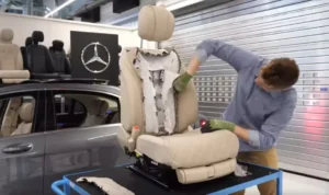 “Jeff upholstering vintage car seat—hands-on restoration with legacy techniques and premium materials”
