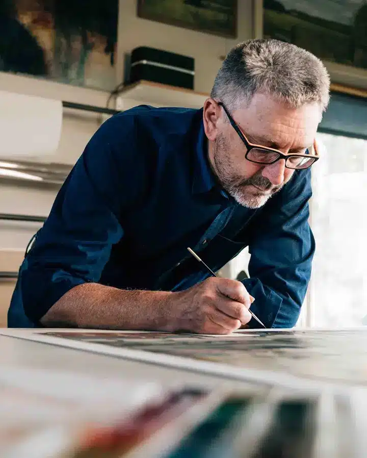 “First Class MasterCraft team member at desk – coordinating upholstery and cabinetry projects in Fort Lee workshop”