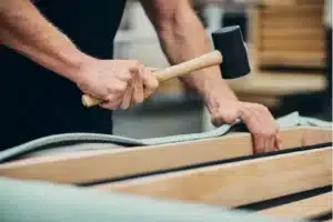 team members on the bench working on sofa back